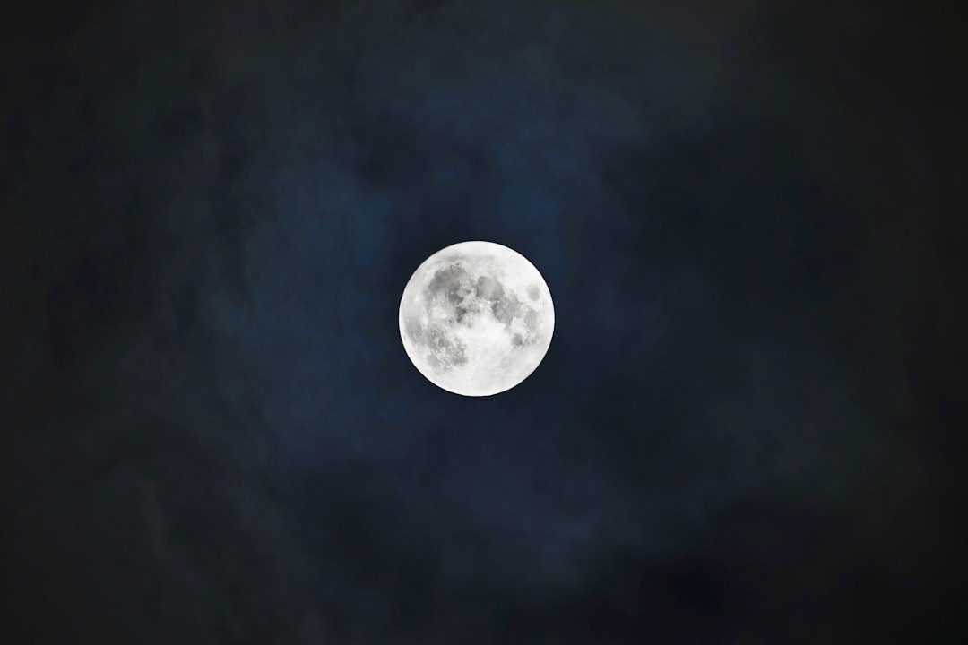 A full moon is seen in the night sky