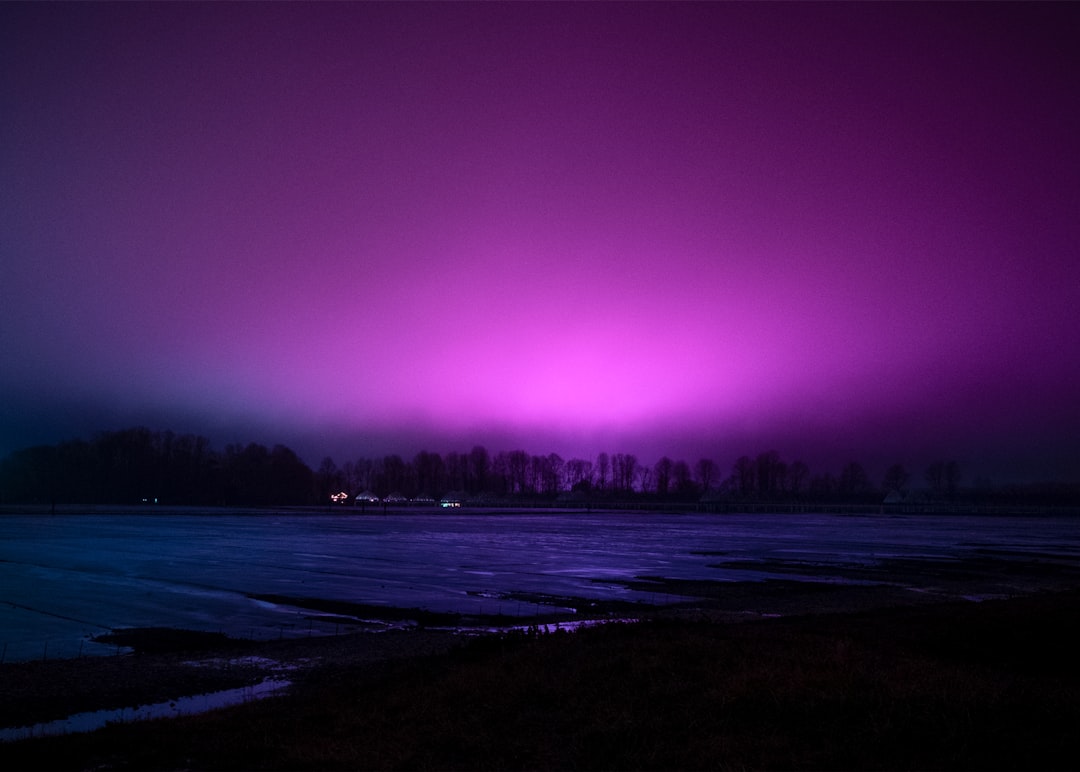 A picture of a purple sky over a body of water