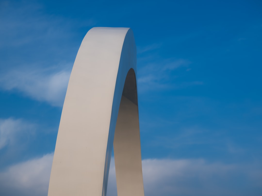 A white arch against a blue sky