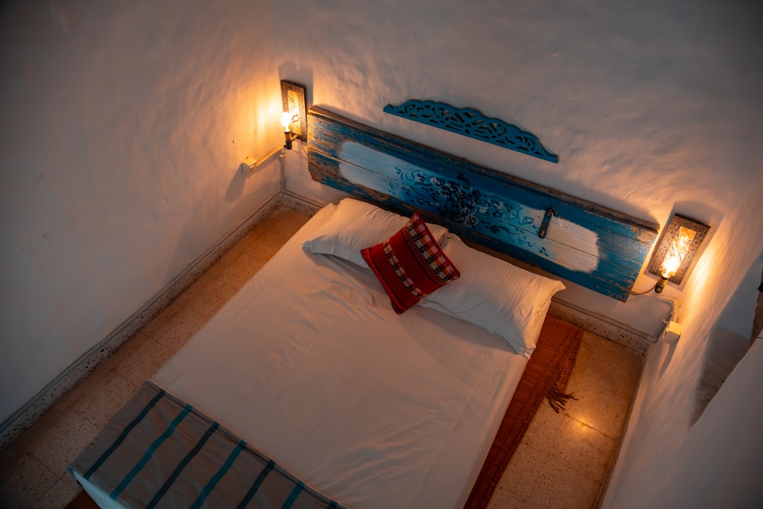 A bedroom with a bed and a night stand