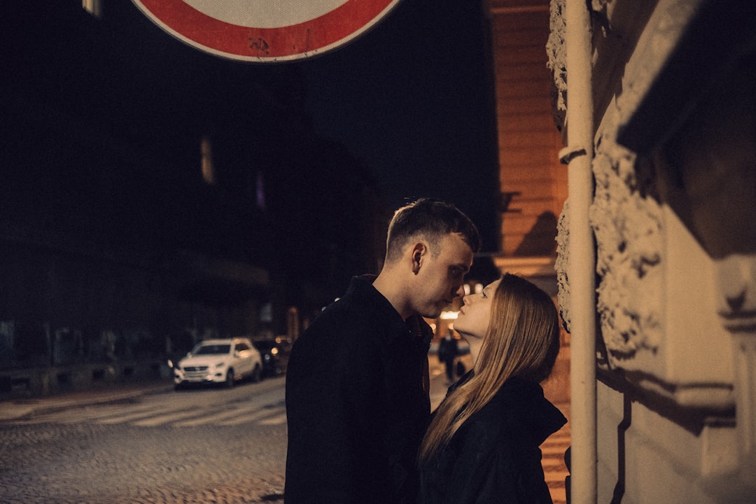 Couple embracing on a city street at night