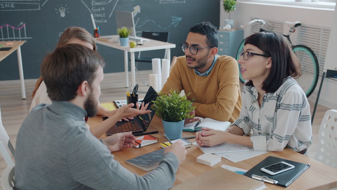 Diverse team collaborating around a table in office.