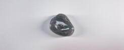 Black energy - black stone on white table