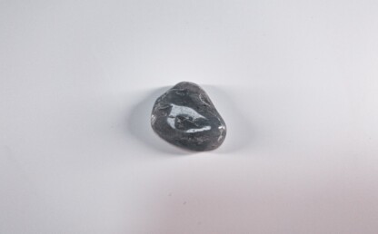 Black energy - black stone on white table